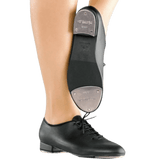 Person wearing black lace up tap shoes