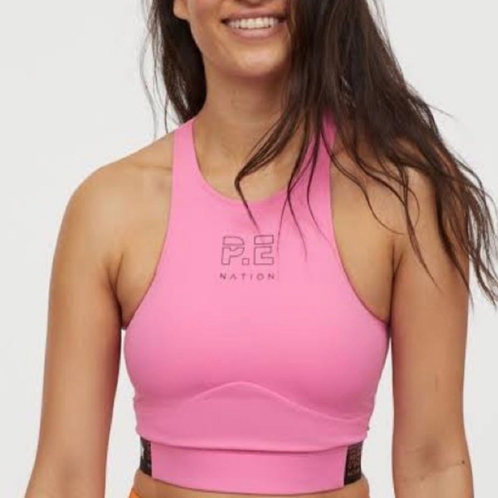 Girl wearing a pink PE Nation long line crop top
