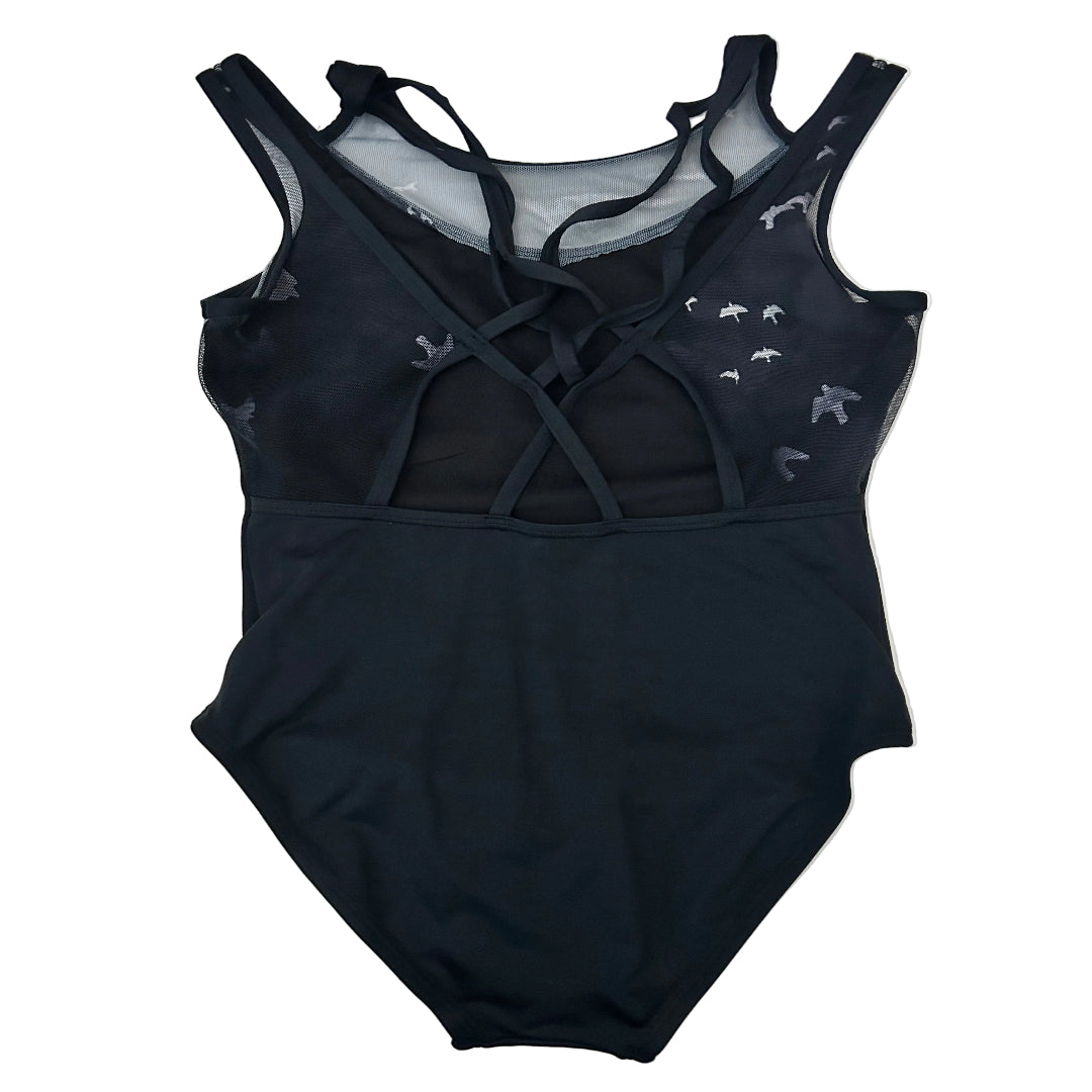 Rear view of a black leotard with a sheer mesh back panel, criss-cross lace-up straps, and small white bird silhouettes printed on the mesh on the upper back, laid flat on a white surface.