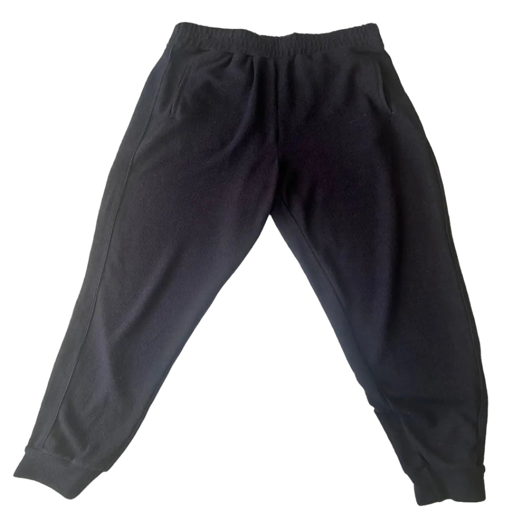 Black jogger sweatpants with an elastic waistband and side pockets, laid flat.