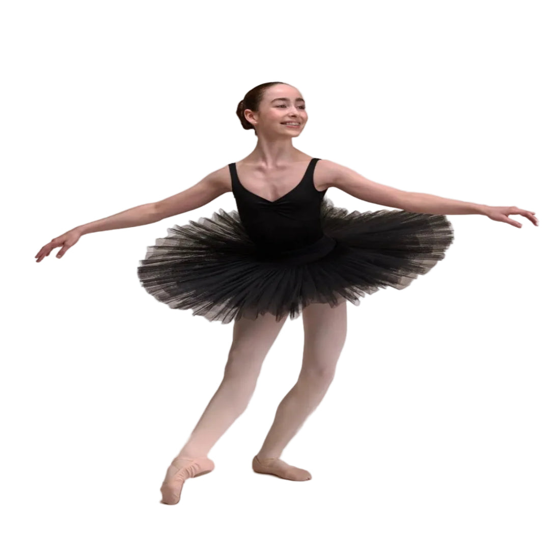A young ballerina wearing a black sleeveless leotard with a black half tulle tutu