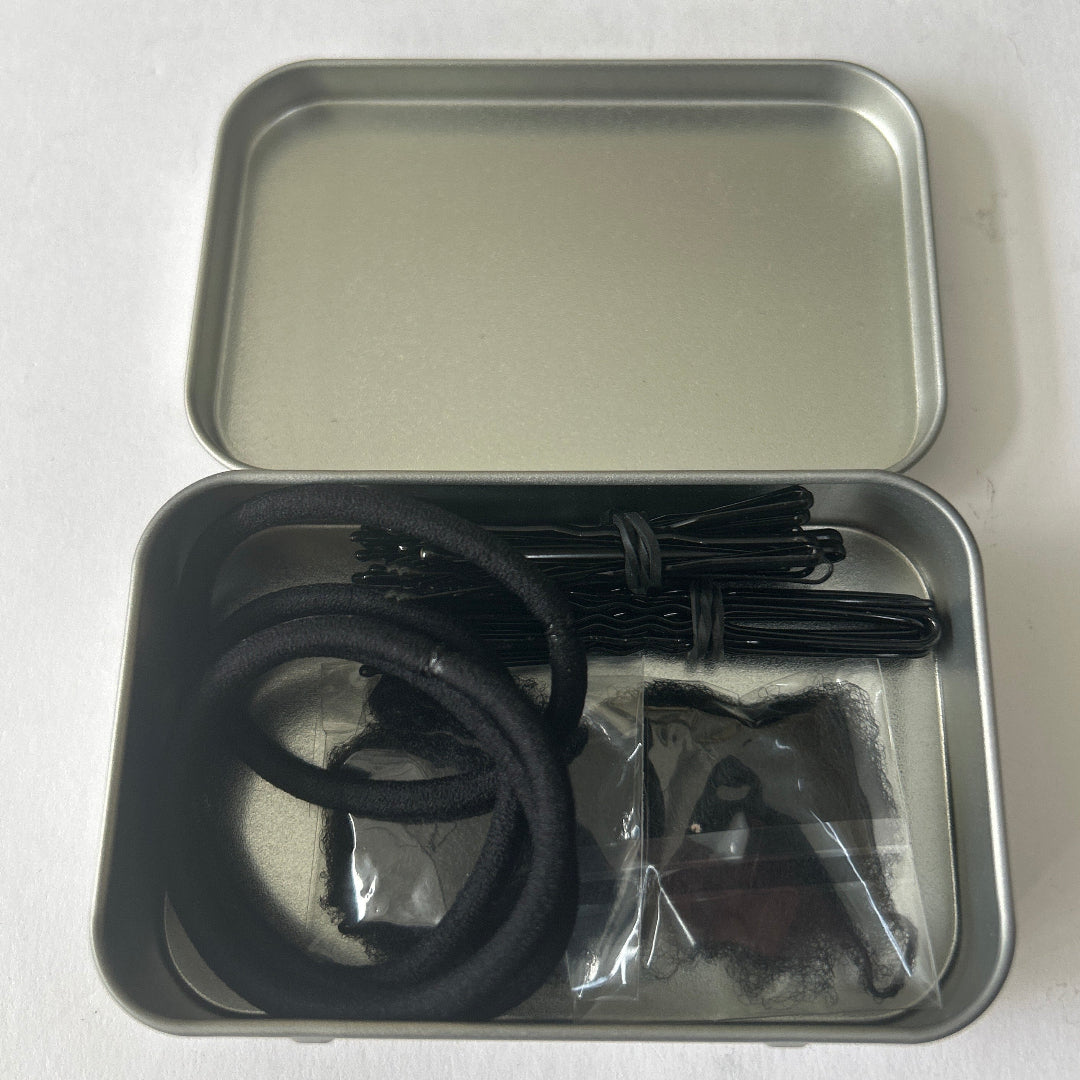 Small silver tin containing black hair accessories
