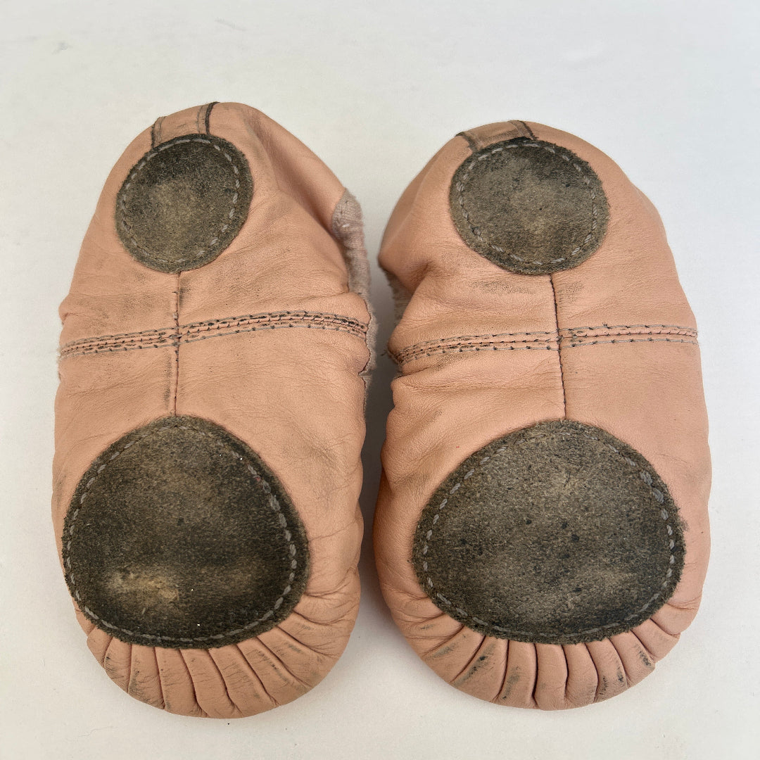 Bottom view of a pair of second hand split sole ballet shoes