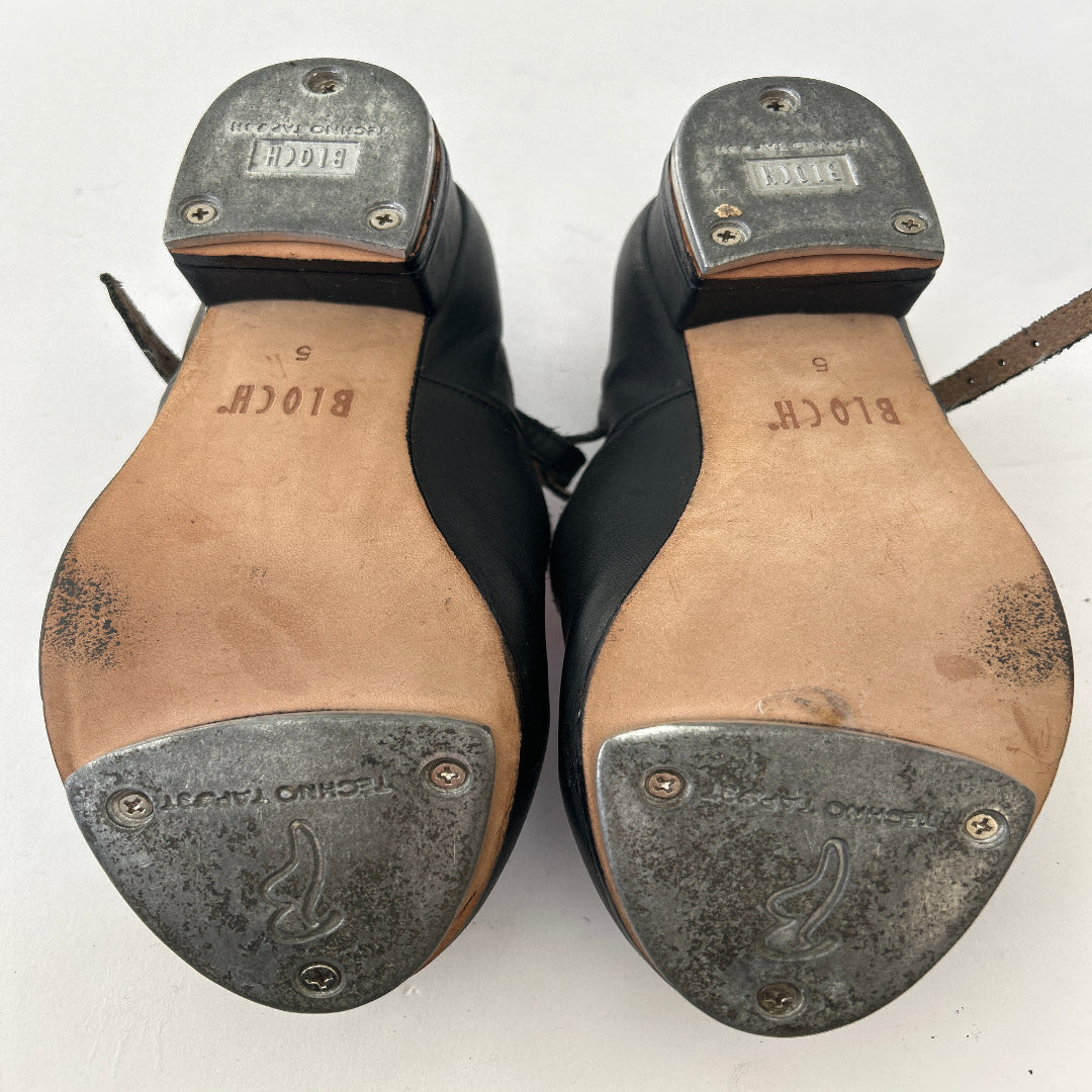 Bottom view of a pair of Bloch black buckle tap shoes