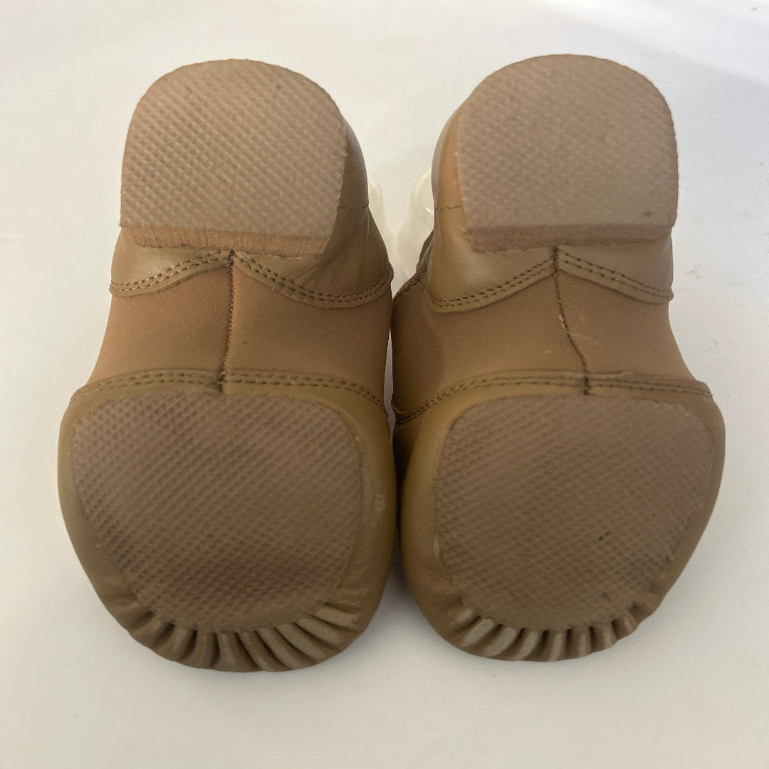 A pair of DanceYou Tan Jazz Shoes, shown from the bottom