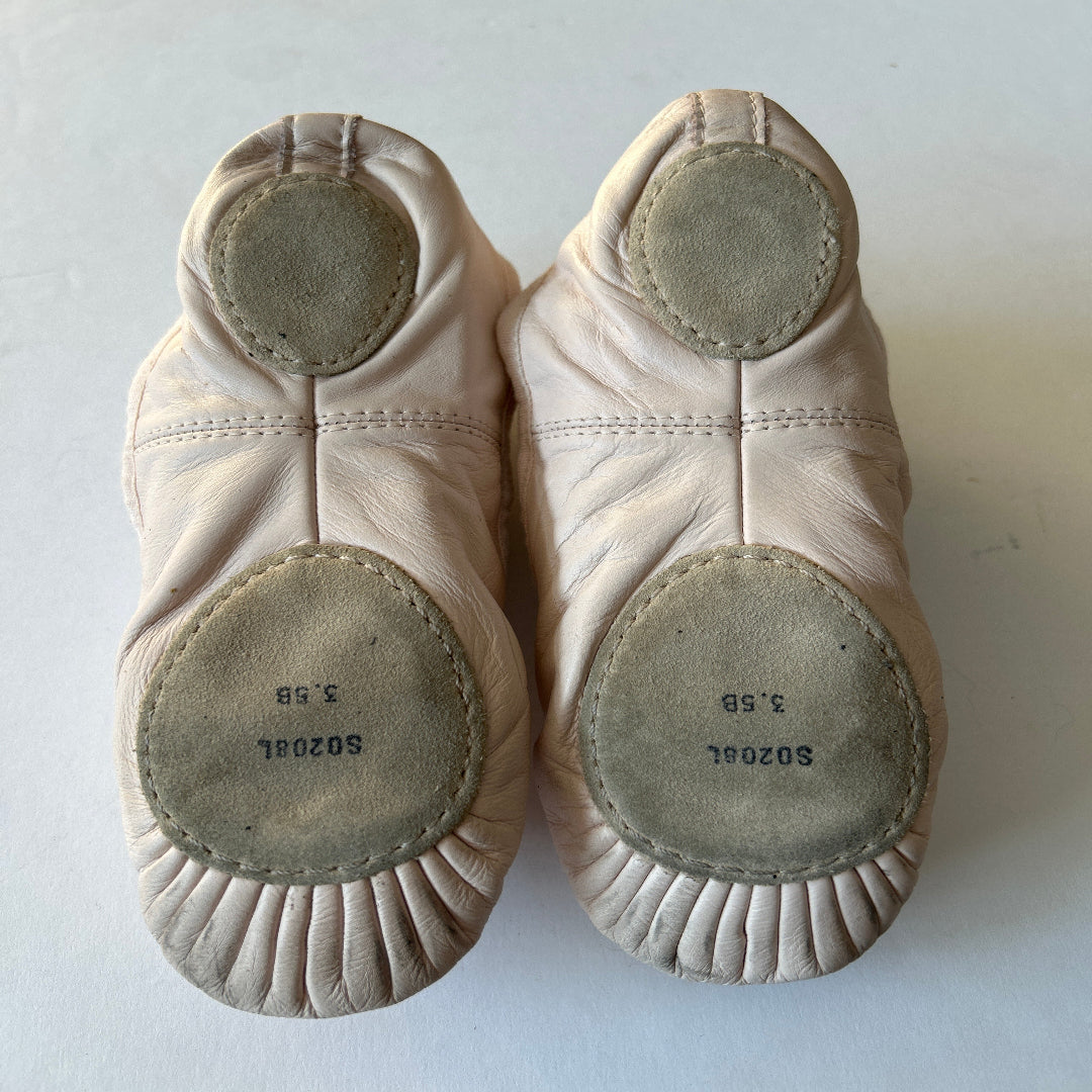 Pair of second hand Bloch ballet shoes showing their split soles