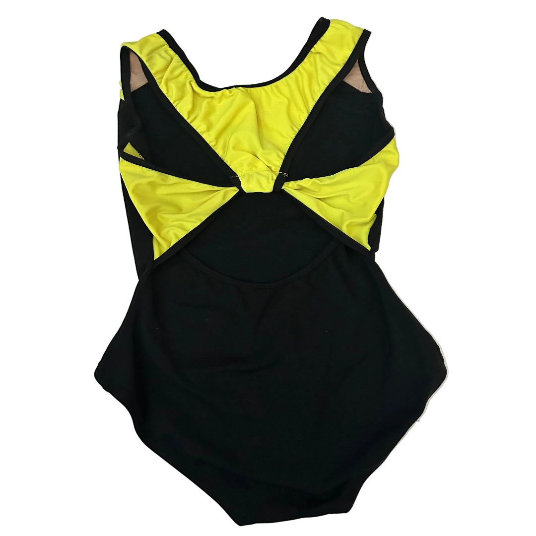 Rear view of a black sleeveless leotard laid flat on a white surface, featuring bright neon yellow panels on the shoulders and back with black trim.