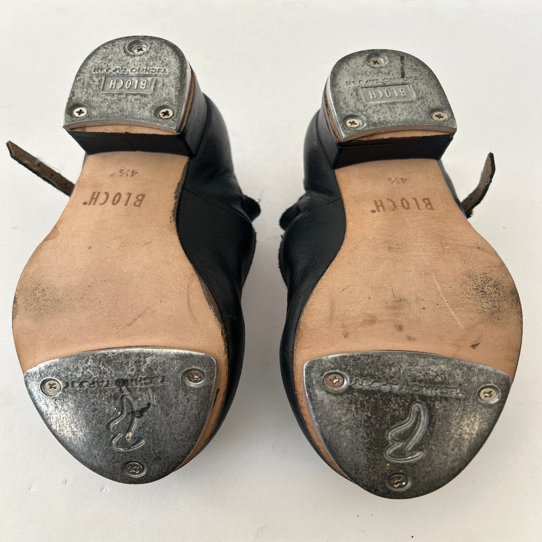 Bottom view of a pair of Bloch black buckle tap shoes
