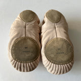 Pair of second hand split sole ballet shoes showing their soles