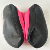 Bottom view of a pair of hot pink shoe covers with black soles