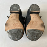 Bottom view of a pair of Bloch Black Buckle Tap Shoes 