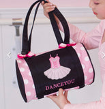 Pink and black polka dot dance bag with ballet design and 'DANCEYOU' text held by a person in a pink outfit.