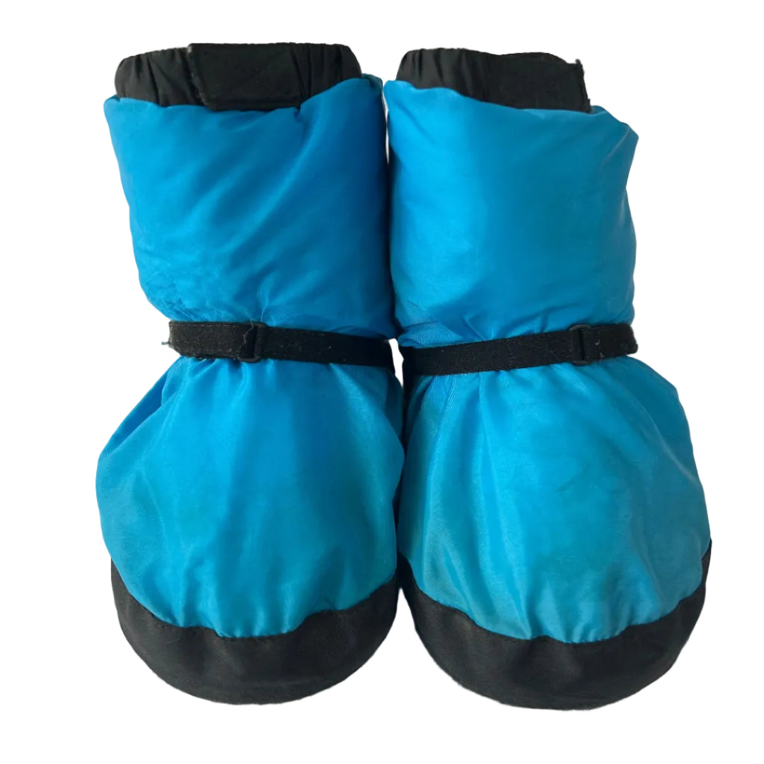 A pair of bright blue boot covers with black trim and adjustable black straps, shown on a plain white background.