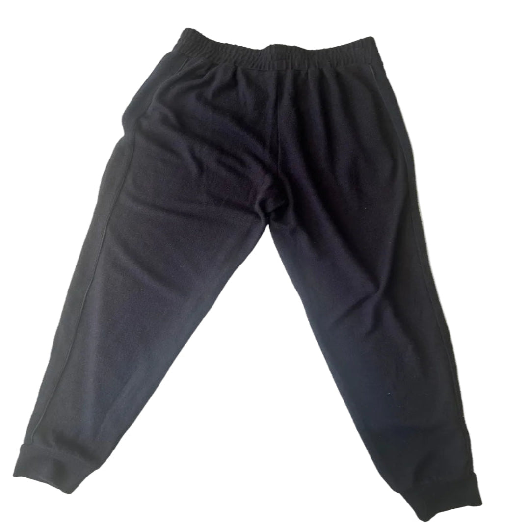 Black sweatpants with an elastic waistband and cuffs, laid flat.
