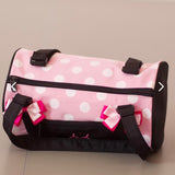 Child's pink and black dance bag with white polka dots and black straps
