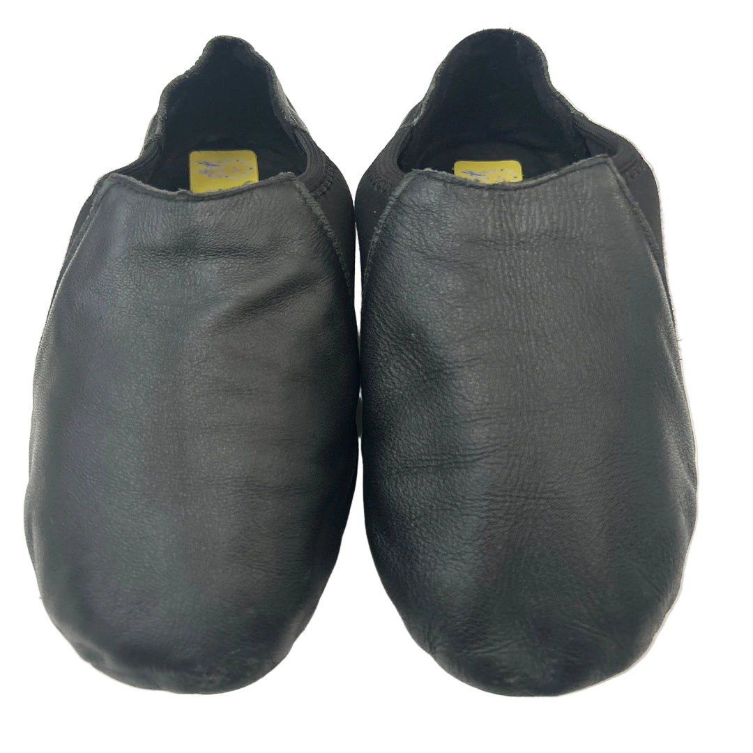 A pair of black leather slip-on shoes photographed from above on a plain white background.